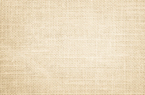 istock Jute hessian sackcloth burlap canvas woven texture background pattern in light beige cream brown color blank. Natural weaving fiber linen and cotton cloth texture as clean empty for decoration. 1369083275