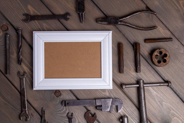 istock photo frame on brown wooden background with working tool 1369083438