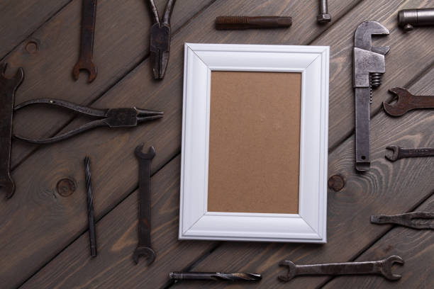istock photo frame on brown wooden background with working tool 1369083446