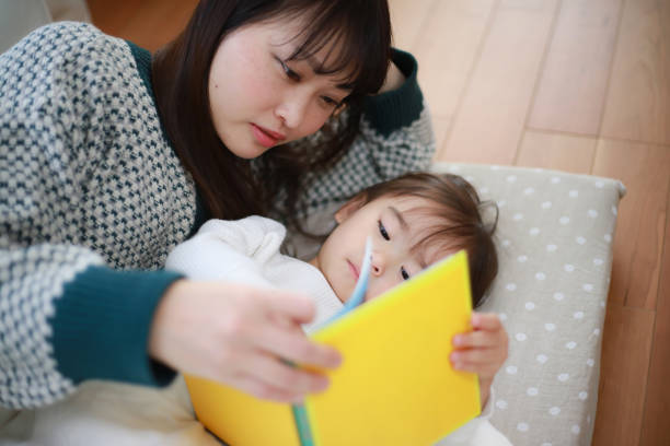 istock Parents and children reading picture books 1369083676