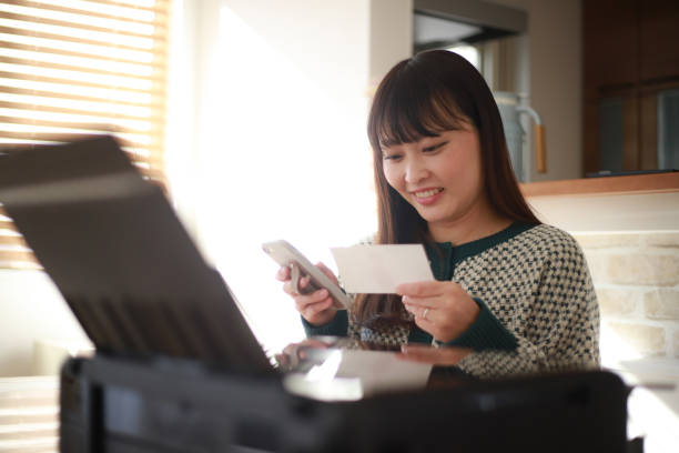 istock Woman printing a photo 1369084179
