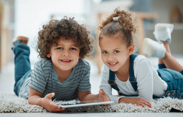istock Shot of two siblings playing together with their digital tablet 1369085096