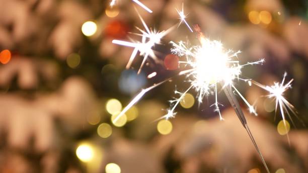istock Sparkler firework burning, Christmas tree in snow, New Year or Xmas bengal light 1369085613