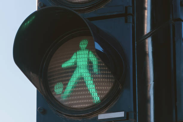 istock Soccer concept, pedestrian traffic light man kicking a ball 1369087473