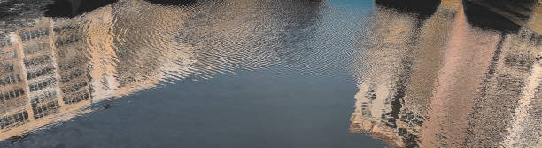 istock blurry reflection of houses in the water 1369087572
