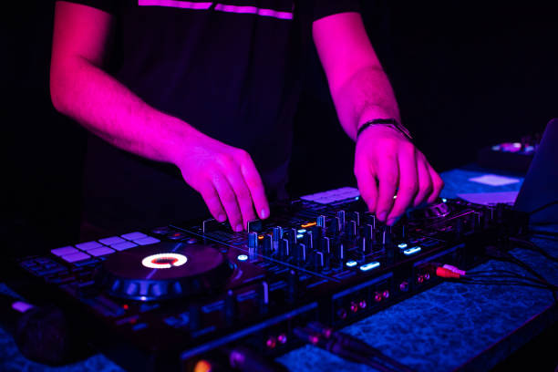 istock DJ mixes electronic music with his hands on a music controller 1369087610