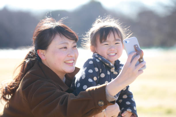 Parents and children taking selfies with a smartphone