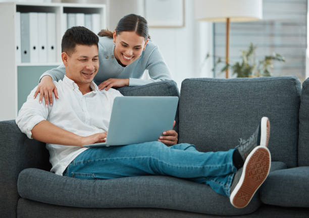 istock Shot of a young couple spending time together using their laptop 1369088909