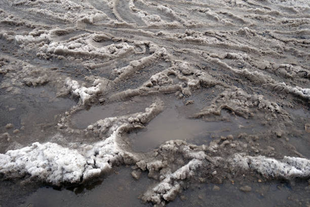 istock Tyre tracks on dirty wet snow road. 1369089735