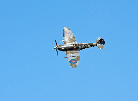 Spitfire in flight, over the Solent, Dorset, England. The Vickers Supermarine Spitfire was one of the most important single seat fighter aircraft flying in the Second World War against Nazi Germany, especially in the defence of England in the Battle of Britain during August 1940 in the clear skies over the English Channel coast