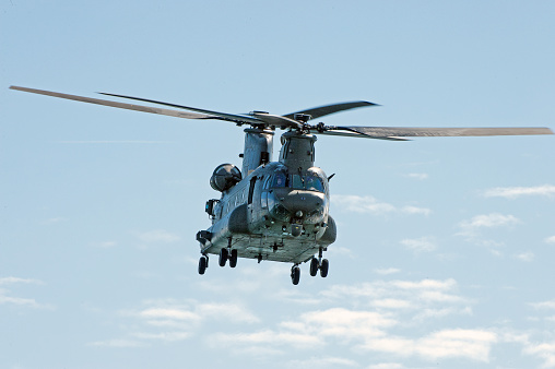 Chinook helicopter in level flight over Poole Bay, English Channel, England.  The Boeing CH-47 Chinook, a tandem rotor heavy lift helicopter developed by American rotorcraft company Vertol,manufactured by Boeing Vertol