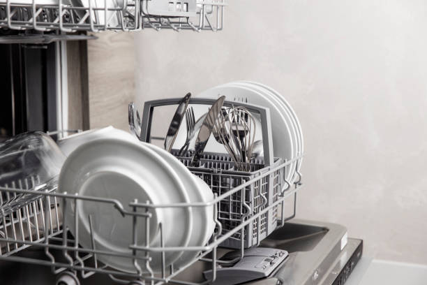 istock Open dishwasher with clean utensil inside, cutlery, glasses, dishes at kitchen 1369091484