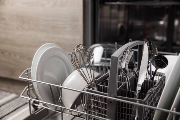 istock Open dishwasher with clean utensil inside, cutlery, glasses, dishes at kitchen 1369091485