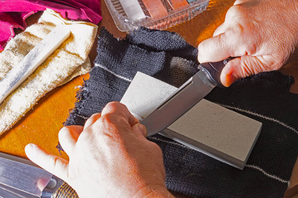 istock Sharpening of knives, with on an abrasive stone, by hand 1369092971