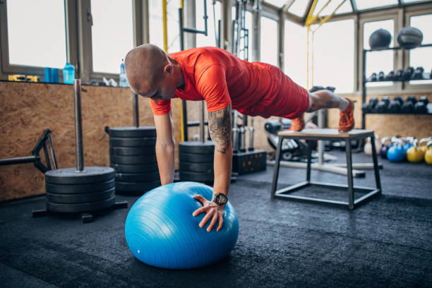 istock Fit man exercising in gym 1369094099