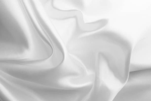 istock White satin silk, elegant fabric for backgrounds 1369095431