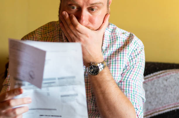 istock Worried man checking bills at home 1369095597