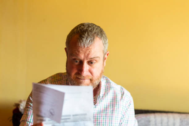istock Worried man checking bills at home 1369095612