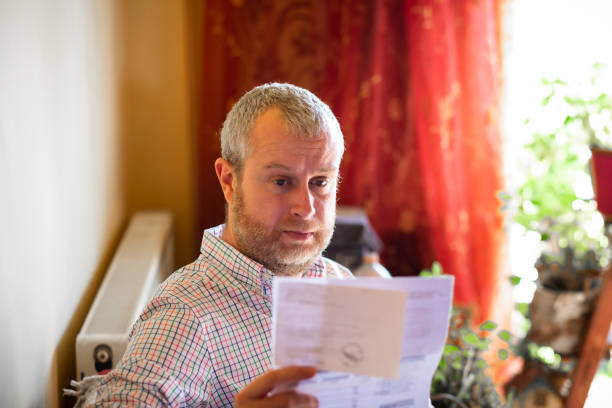 istock Worried man checking bills at home 1369095615