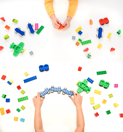 Close up kid boy hands playing with toy bricks on white background. Copy space for your text.