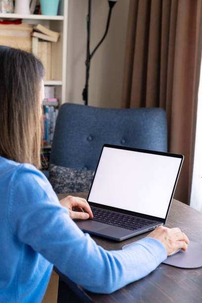 istock Woman using laptop at home 1369095936