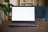 istock Blank screen modern laptop on table 1369096091