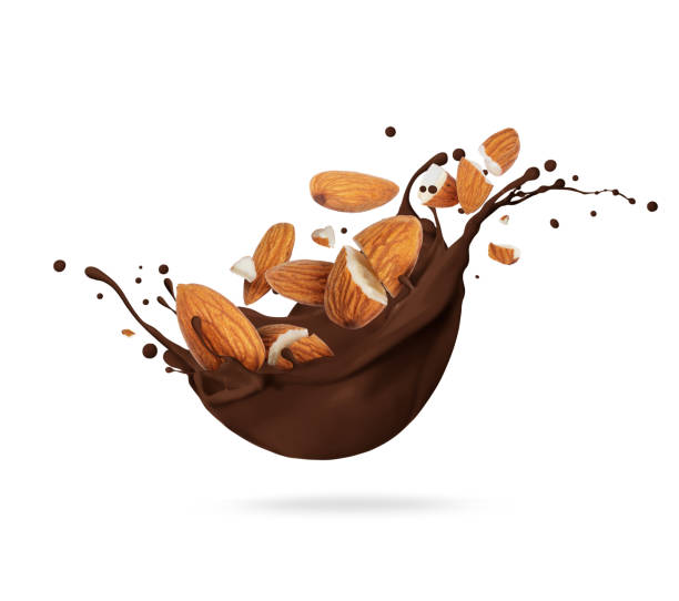 istock Dried crushed almonds in chocolate splashes isolated on white background 1369097275
