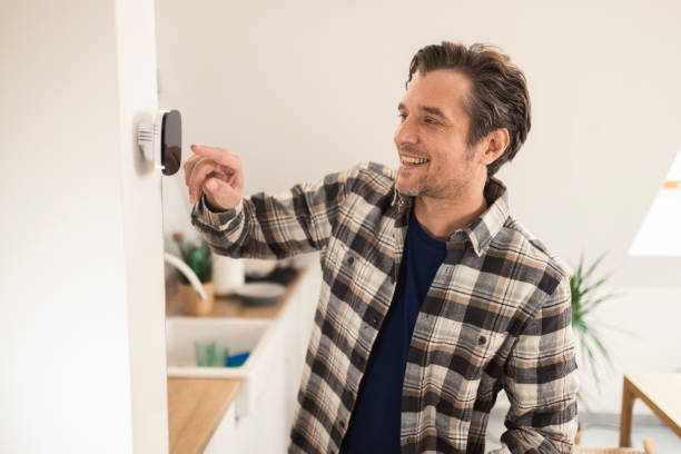 istock Portrait of a happy man setting up home devices using the smart home system 1369099784