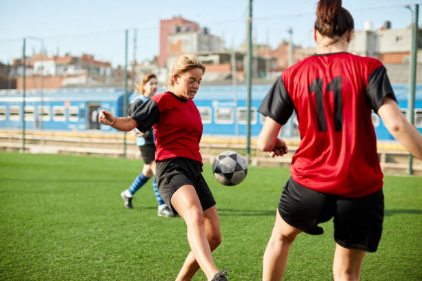 Female soccer team in the field pracitcing.
