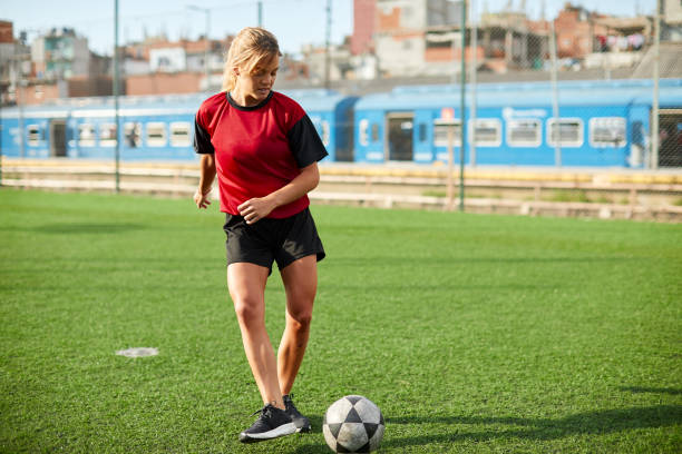istock Female soccer player striking the ball. 1369100981