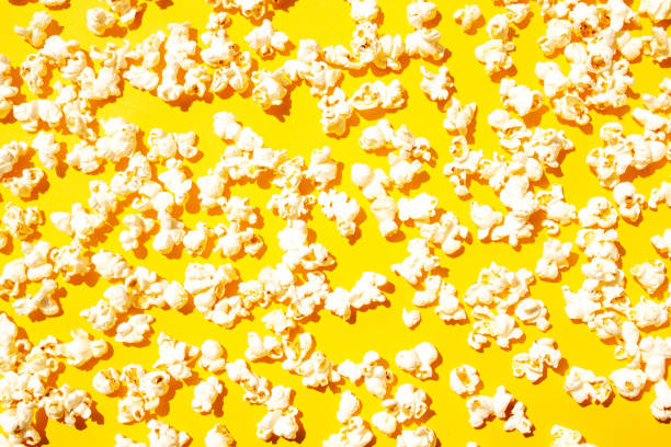istock Popcorn on a yellow background texture. Flat Lay Style 1369101001