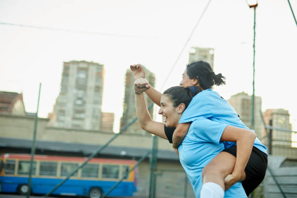 istock Two teammates hug each other after scoring a goal. 1369101412