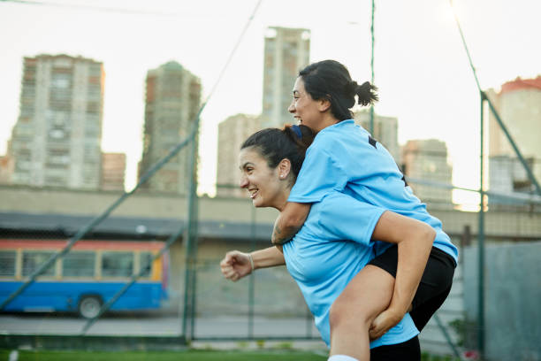 istock Two teammates hug each other after scoring a goal. 1369101461