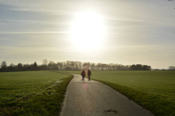 Father and son walking in a field at dusk