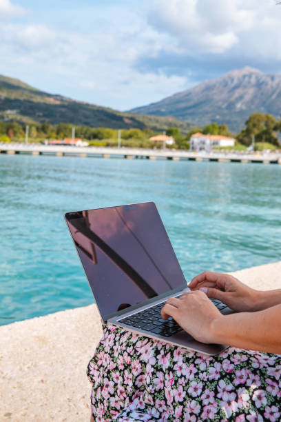 istock smiling woman freelancer working on laptop outdoors at city harbor 1369103169