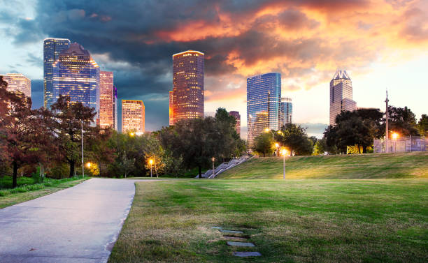 istock Houston Texas modern skyline at sunset twilight from park lawn 1369104288