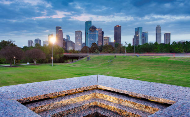 istock Houston Texas modern skyline at sunset twilight from park lawn 1369104438