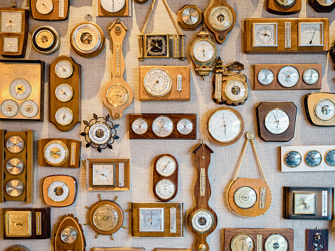 Antique wall wooden clock with hands of the clock and gold pendulum