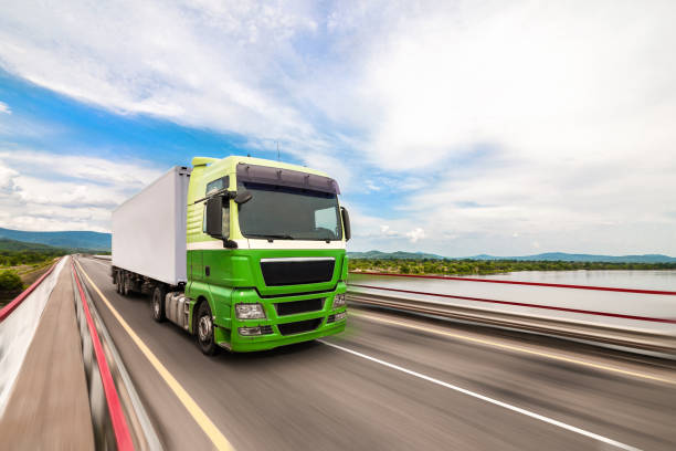 istock Green Man truck moving by a bridge 1369106709