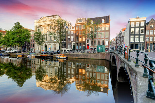 istock Amsterdam Canal houses at sunset reflections, Netherlands 1369106835