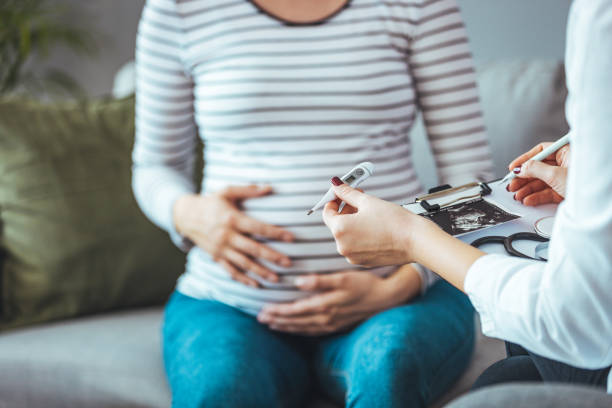 istock A pregnant woman during a routine check up with her doctor. 1369107188