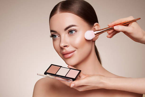 istock Makeup artist applies eye shadow 1369110187