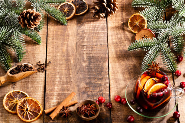 istock Christmas mulled wine with spices on a wooden rustic table. 1369111293