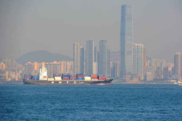 Container ship in Hong Kong Container ship on the South China sea off Hong Kong coast, one of the busiest ports in the world. international commerce center stock pictures, royalty-free photos & images