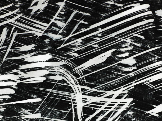 istock Patterns of white paint from a brush on a black background 1369111522