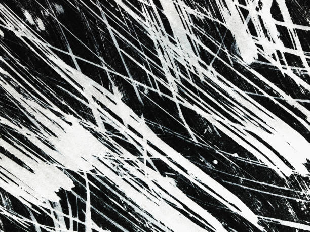 istock Patterns of white paint from a brush on a black background 1369113048