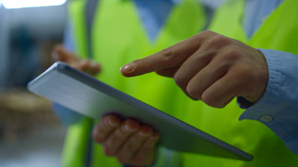 istock Closeup warehouse workers tablet information checking manufacture inspection 1369114089