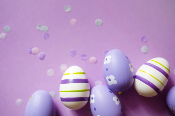 istock painted easter purple eggs with ornament and decor on pastel background. copy space 1369114144