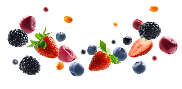 Many different berries in the form of a frame on a white background.