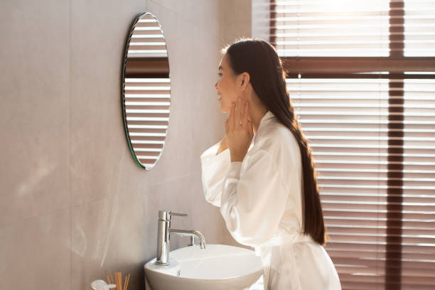 istock Side view of attractive korean lady touching her face 1369114268